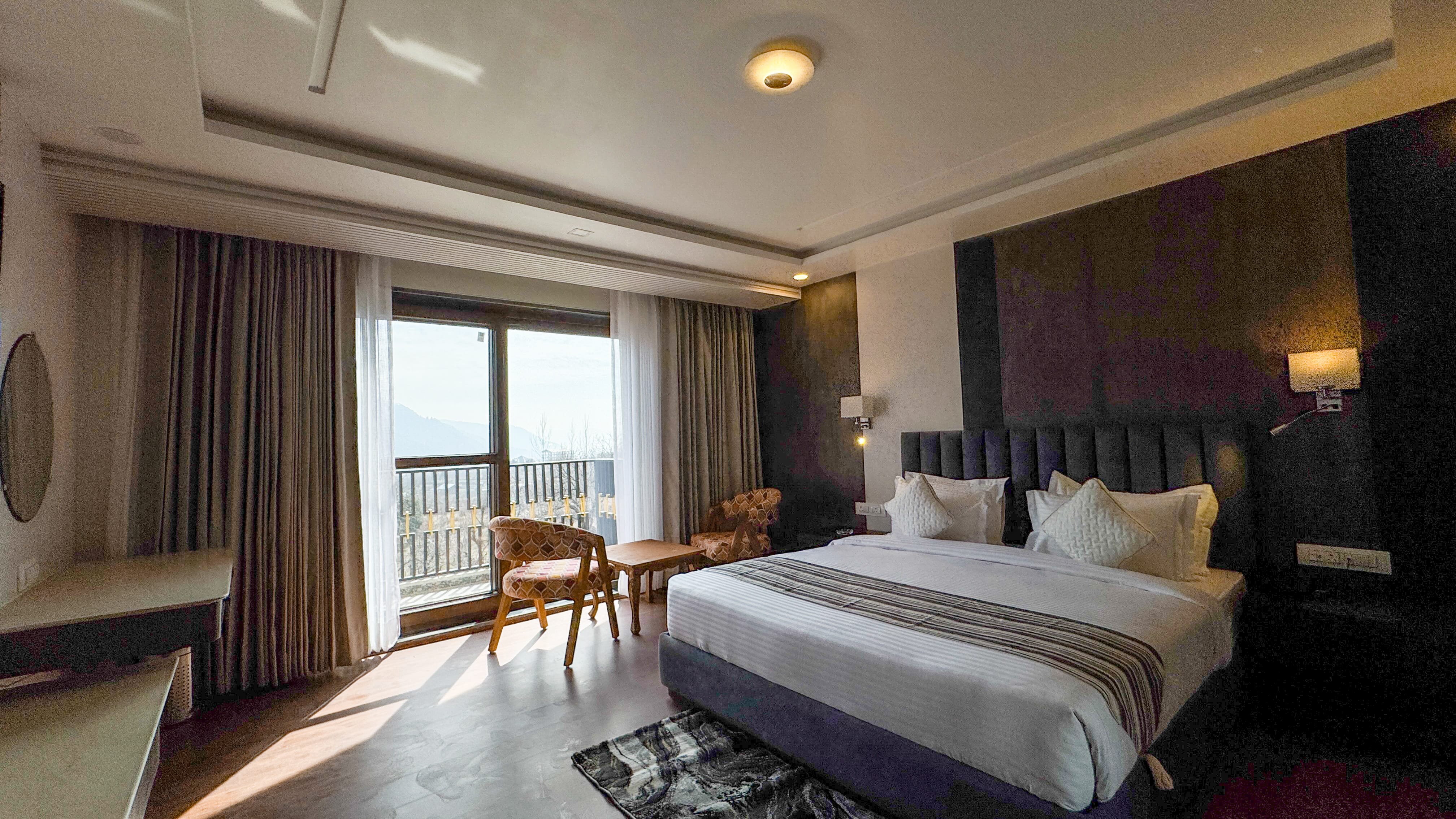 Stunning mountain view through hotel room balcony in Pahalgam