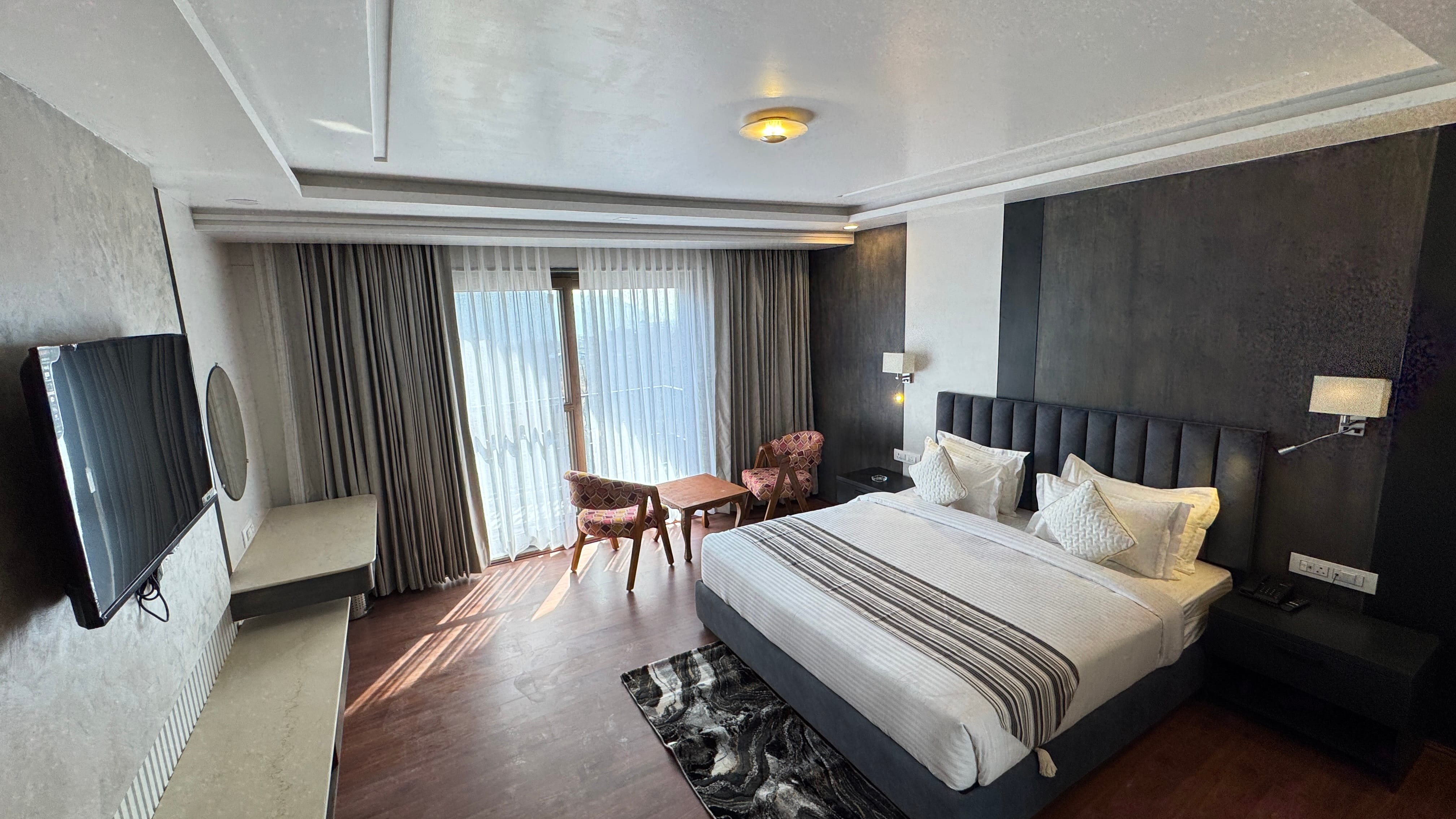 Deluxe Premium room with dark headboard and balcony