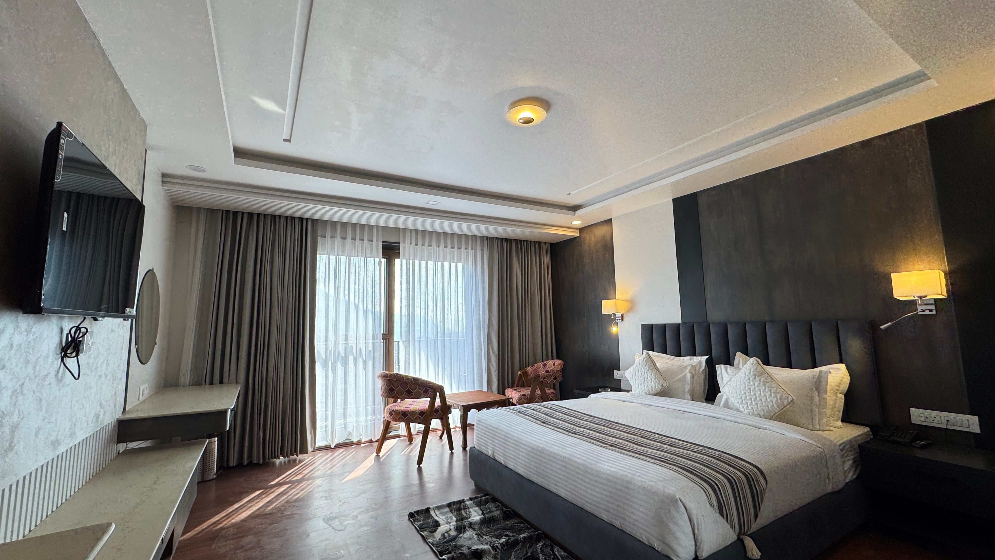 Deluxe Premium room interior with TV and headboard