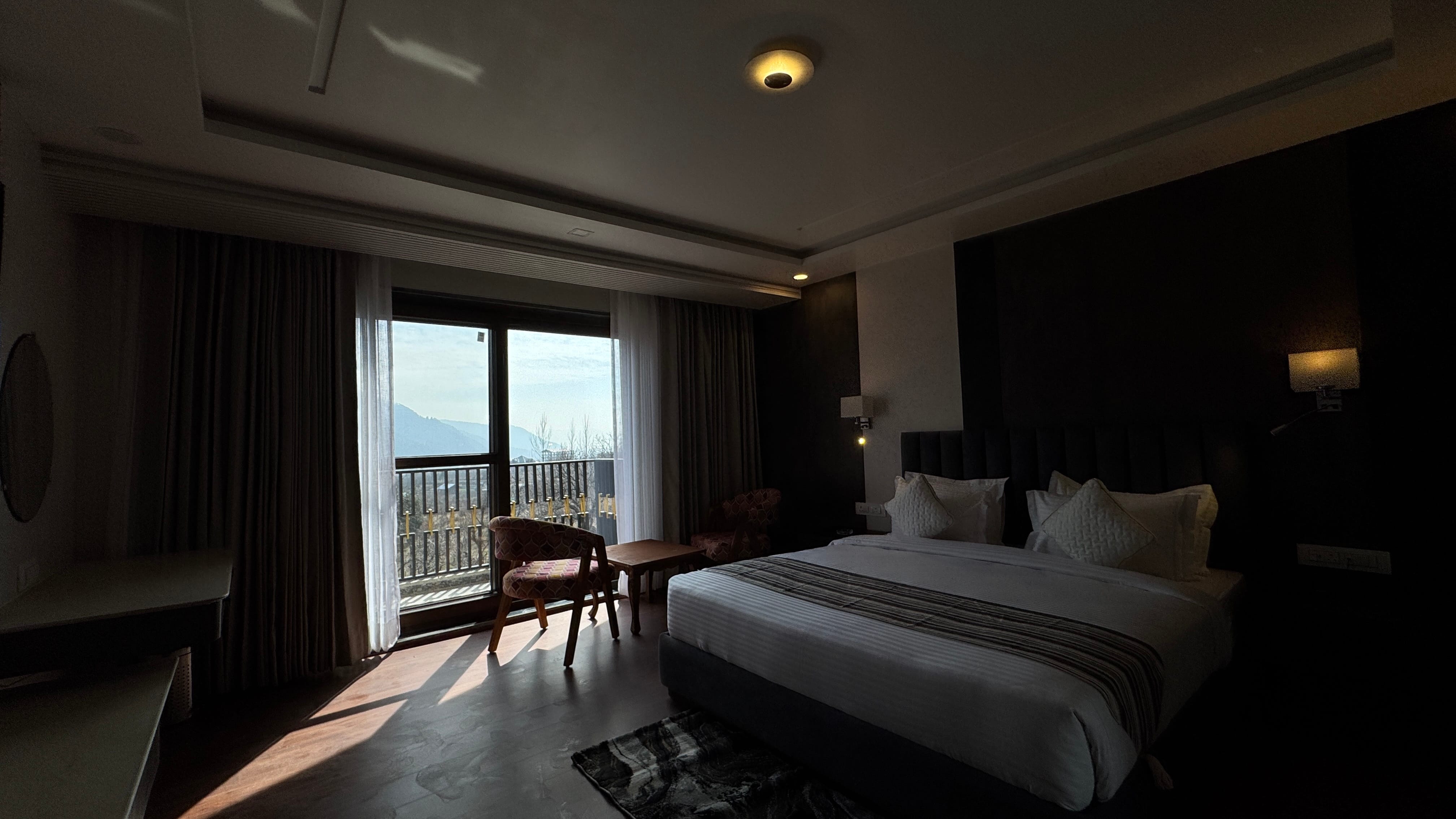 Dark and moody room interior with stunning mountain view through window