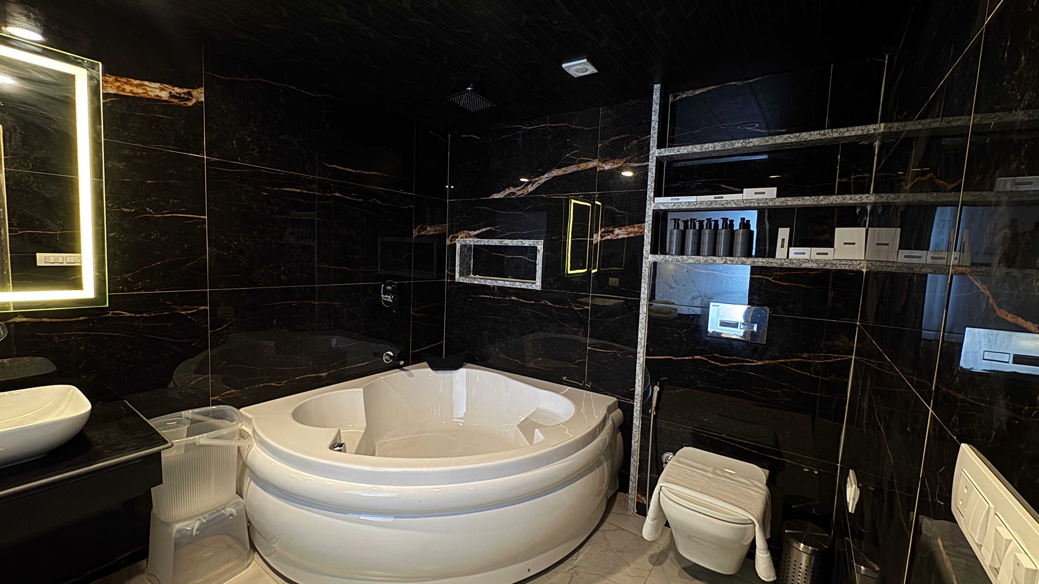 Luxury Jacuzzi Suite bathroom with black marble at Emroz by Kings Resort