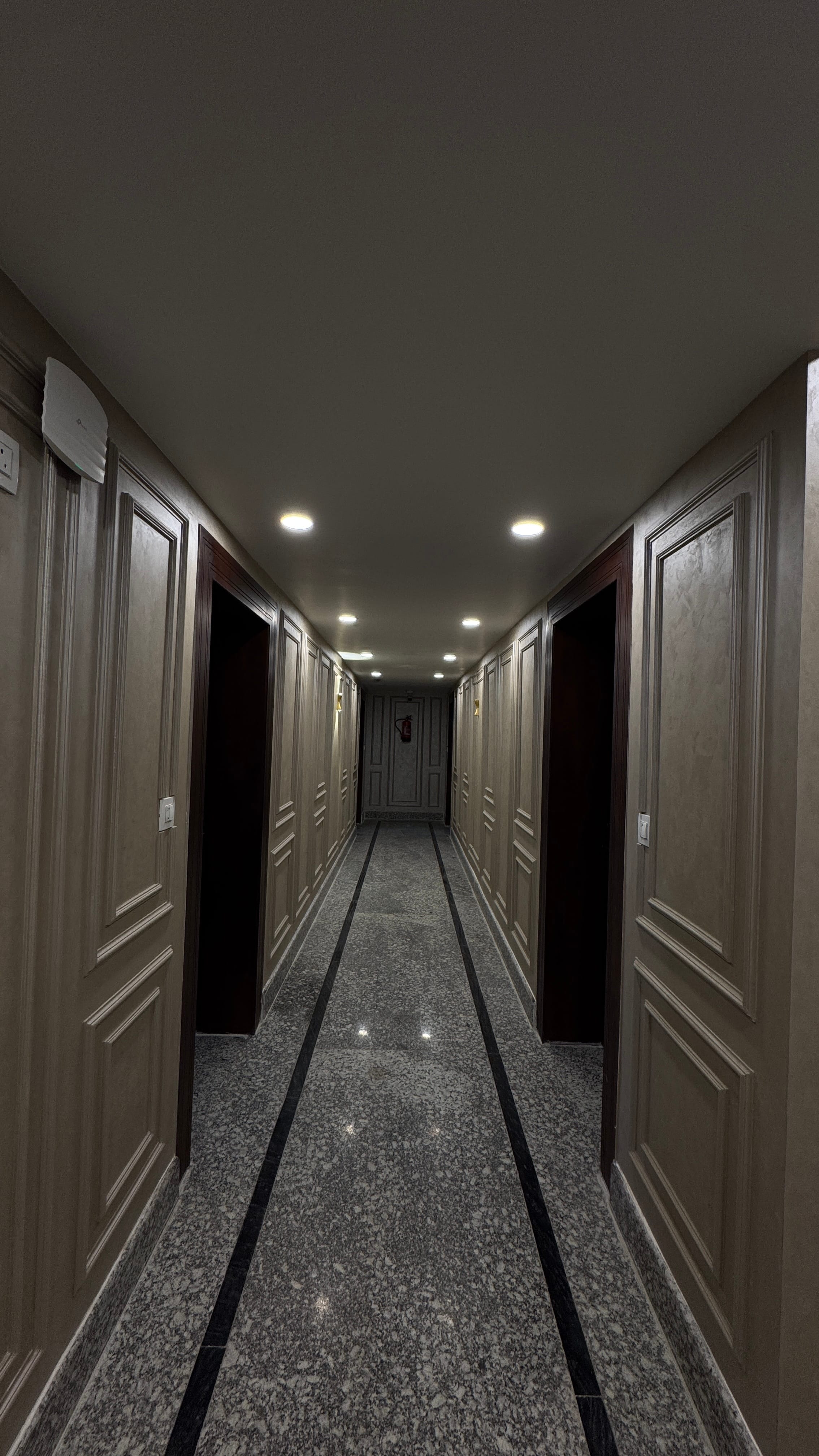 Long elegant corridor inside Emroz by Kings Resort with warm lighting
