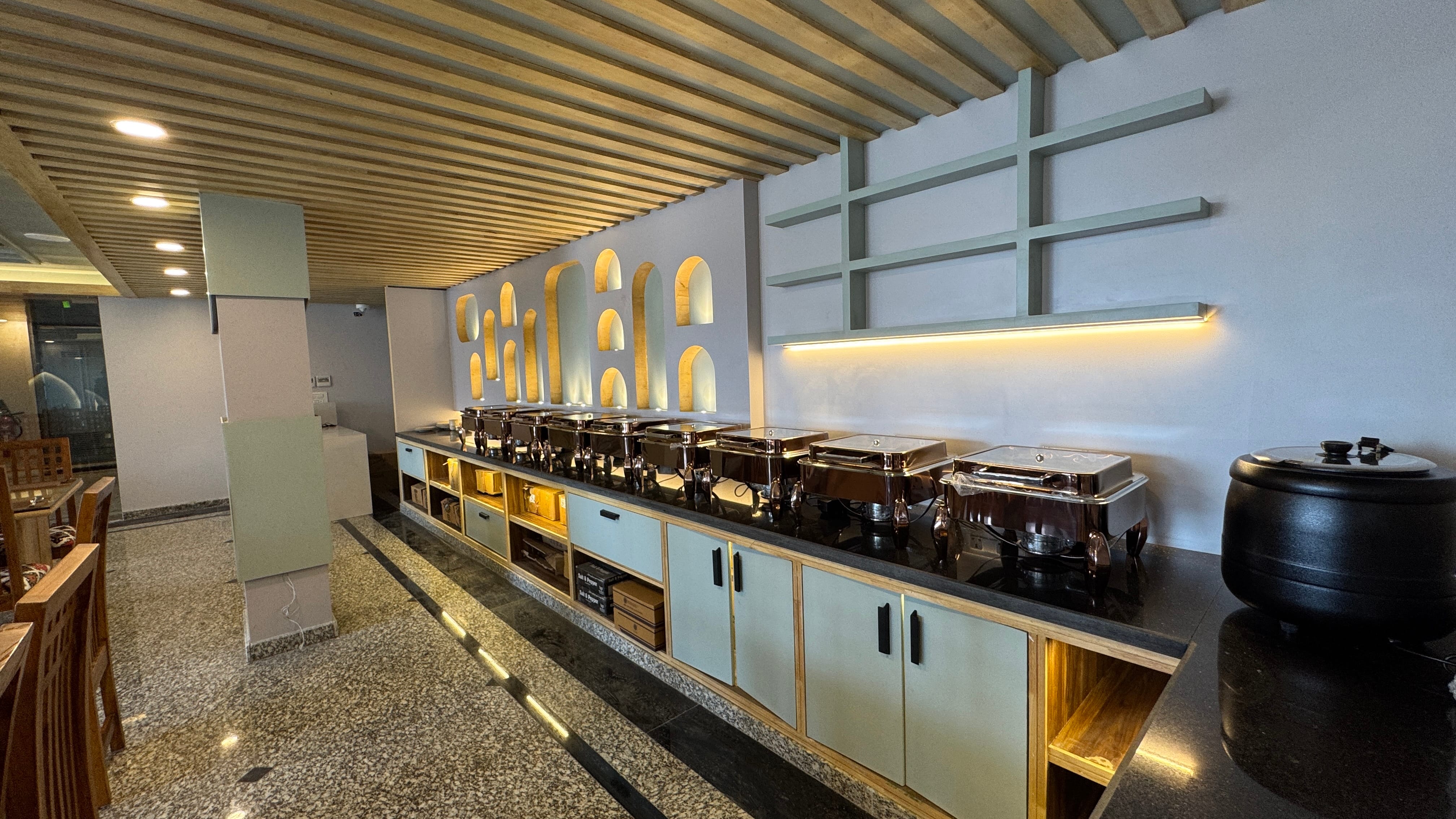 Buffet counter with beautifully arched wall design and food display